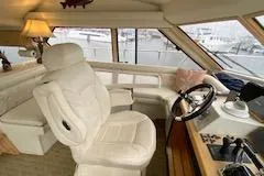 Slide: The Image of Interior of 1995 Navigator 50 yacht with white captain's chair and helm. - 41