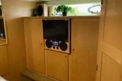 Slide: The Image of Interior of 1995 Navigator 50 yacht with wooden cabinetry and entertainment system. - 46