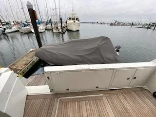 Slide: The Image of Covered boat docked at marina, Navigator 50, 1995 model, with surrounding yachts. - 7