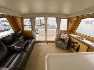Slide: The Image of Interior of 1995 Navigator 50 yacht with leather seating and marina view. - 8