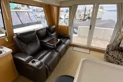 Slide: The Image of Interior of 1995 Navigator 50 yacht with leather seating and marina view. - 9