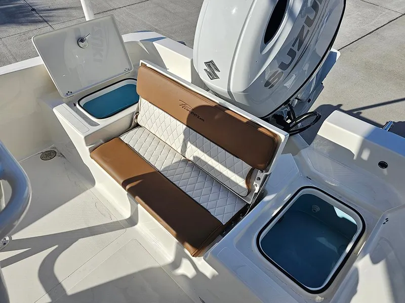 Slide: The Image of 2025 Pioneer 220 Bay Sport boat interior with cushioned seating and storage compartments. - 11