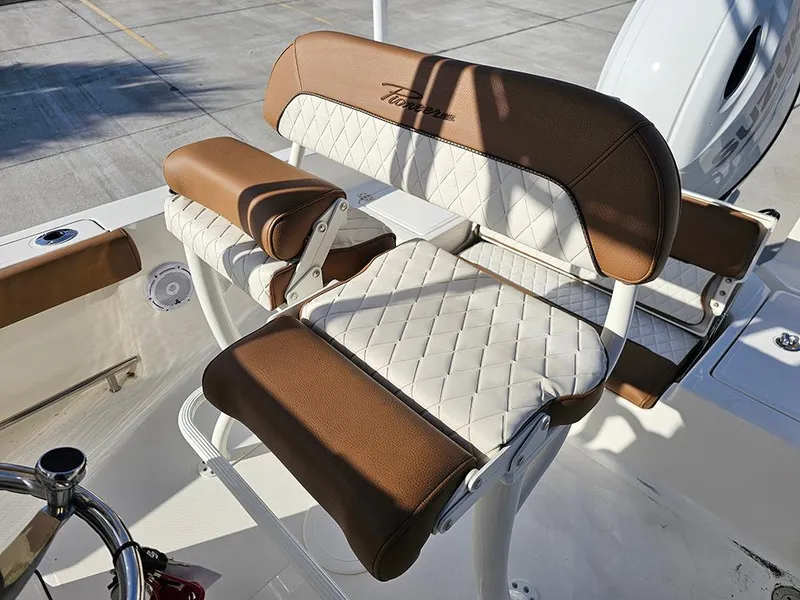 Slide: The Image of 2025 Pioneer 220 Bay Sport boat seat with brown and white upholstery. - 13