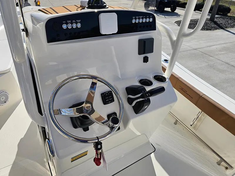 Slide: The Image of 2025 Pioneer 220 Bay Sport boat console with steering wheel and controls. - 14