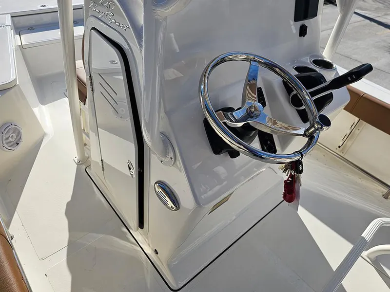Slide: The Image of 2025 Pioneer 220 Bay Sport boat console with steering wheel and controls. - 17