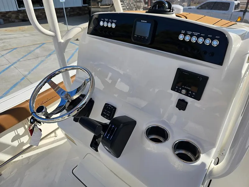 Slide: The Image of 2025 Pioneer 220 Bay Sport boat console with steering wheel and controls. - 25