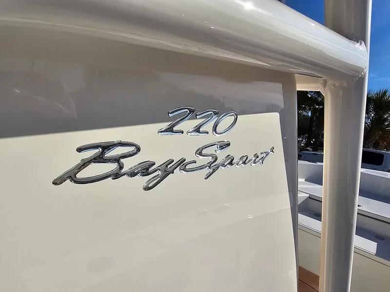 Slide: The Image of 2025 Pioneer 220 Bay Sport boat logo on a sleek white surface. - 31