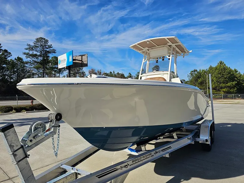 Slide: The Image of 2025 Pioneer 220 Bay Sport boat on trailer under clear blue sky. - 5