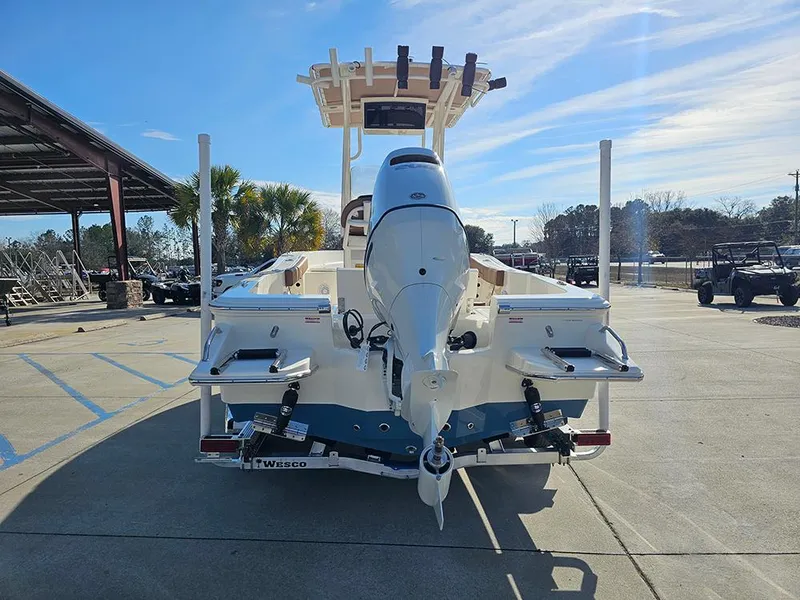 Slide: The Image of 2025 Pioneer 220 Bay Sport boat, rear view, parked outdoors under clear sky. - 8