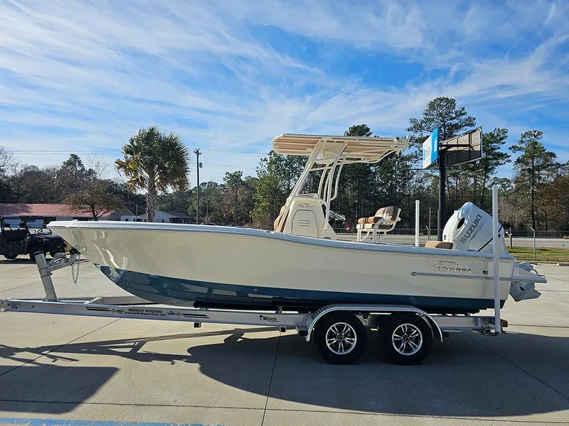 Slide: The Image of 2025 Pioneer 220 Bay Sport boat on trailer, parked outdoors under clear sky. - 9
