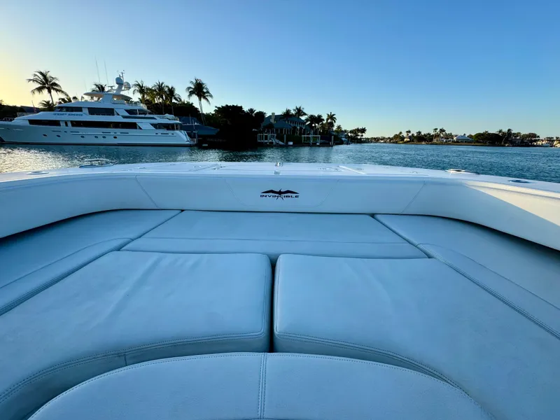 Slide: The Image of Invincible 37 Catamaran 2019 on serene water with yachts and palm trees in the background. - 27