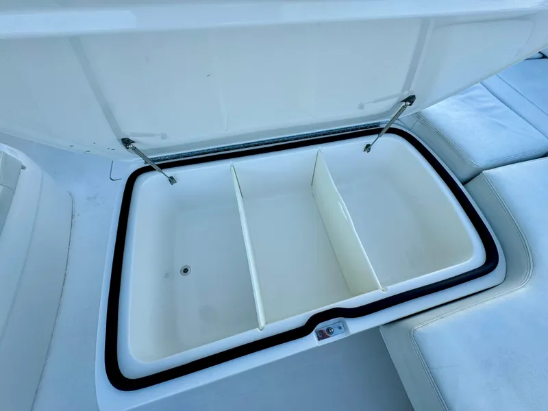 Slide: The Image of Open storage compartment on 2019 Invincible 37 Catamaran with dividers and cushioned seating. - 37