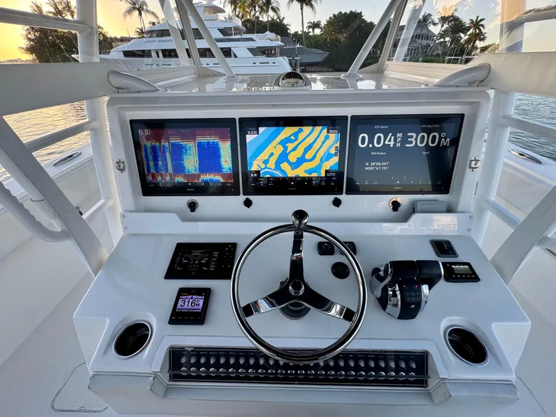 Slide: The Image of Cockpit of 2019 Invincible 37 Catamaran with advanced navigation displays and controls. - 4