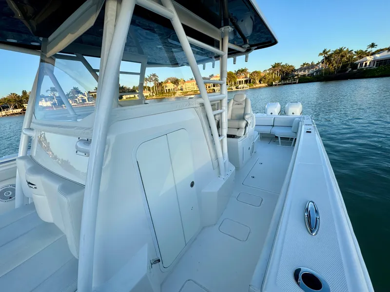 Slide: The Image of 2019 Invincible 37 Catamaran on calm water, showcasing spacious deck and sleek design. - 40