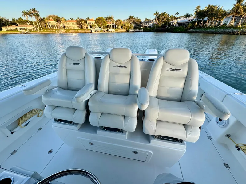 Slide: The Image of Luxurious seating on 2019 Invincible 37 Catamaran, overlooking serene waterfront homes. - 43