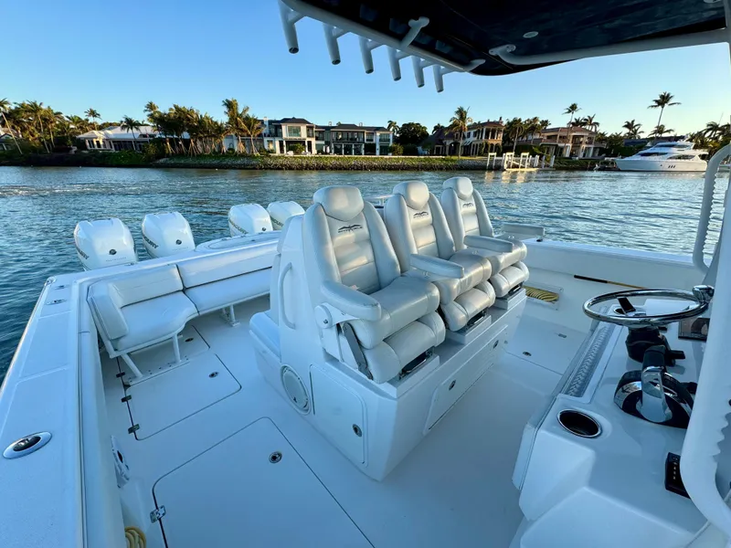 Slide: The Image of 2019 Invincible 37 Catamaran with luxurious seating, docked near waterfront homes. - 47