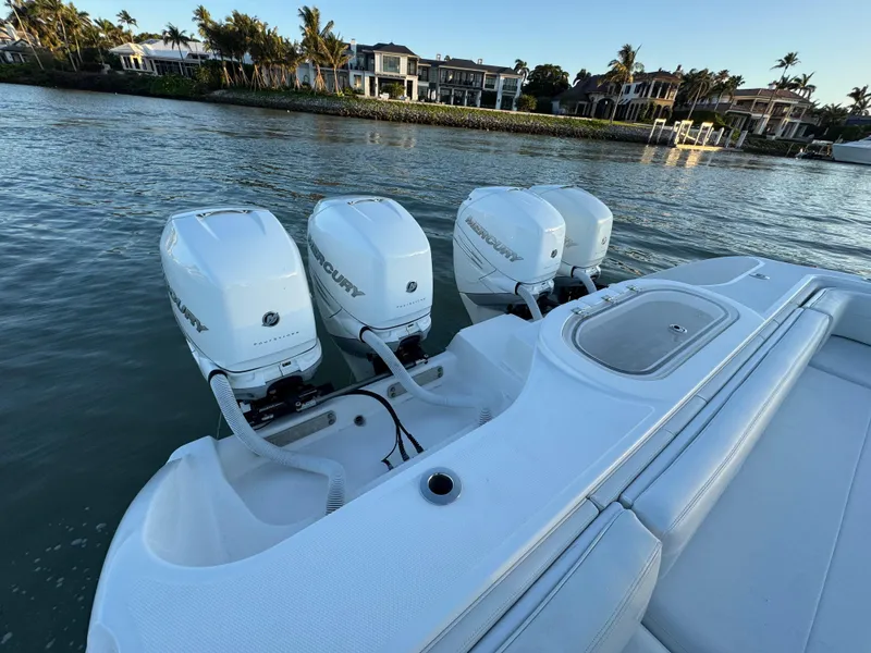 Slide: The Image of 2019 Invincible 37 Catamaran with triple outboard engines on calm water. - 49
