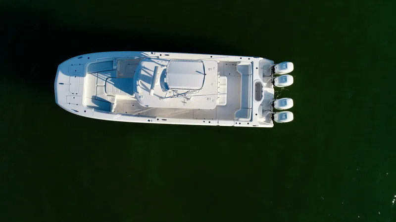 Slide: The Image of Aerial view of 2019 Invincible 37 Catamaran with triple outboard engines on calm water. - 7
