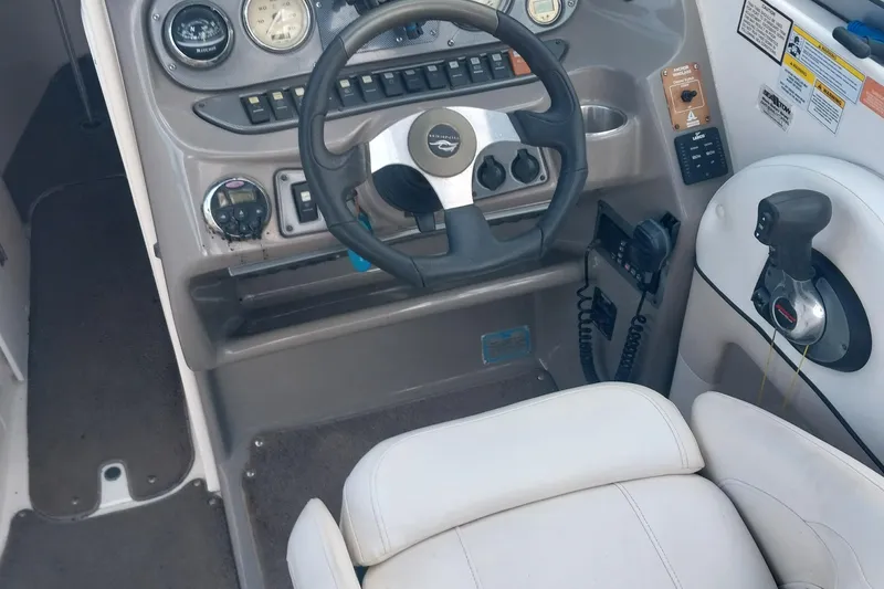 Slide: The Image of 2009 Rinker 296 Captiva Bowrider cockpit with steering wheel and control panel. - 4