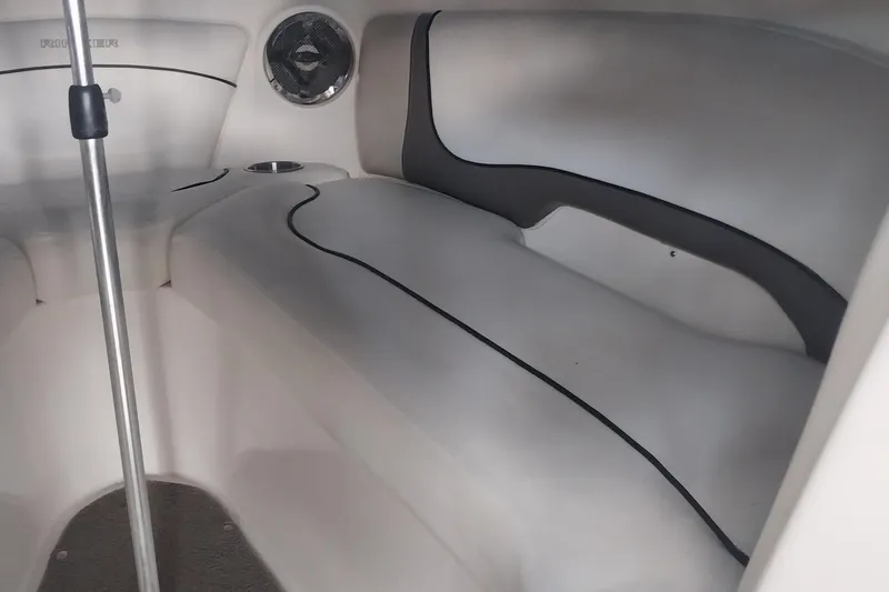 Slide: The Image of 2009 Rinker 296 Captiva Bowrider interior seating with speaker and cup holder. - 9