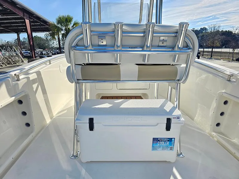 Slide: The Image of 2025 Bulls Bay 230 Center Console boat interior with cooler and rod holders. - 14