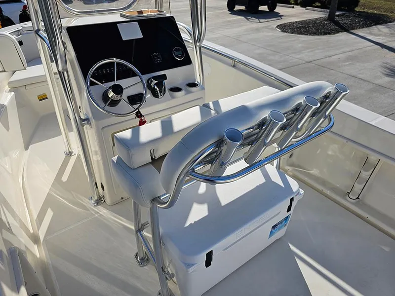 Slide: The Image of 2025 Bulls Bay 230 Center Console boat interior with steering wheel and rod holders. - 15