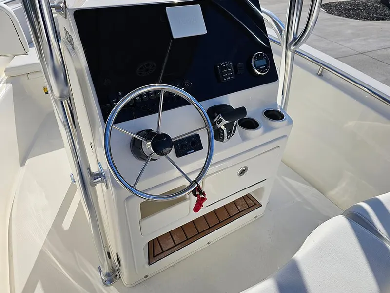 Slide: The Image of 2025 Bulls Bay 230 Center Console boat steering wheel and control panel. - 18