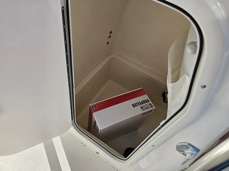 Slide: The Image of Storage compartment in 2025 Bulls Bay 230 Center Console boat with a box inside. - 21