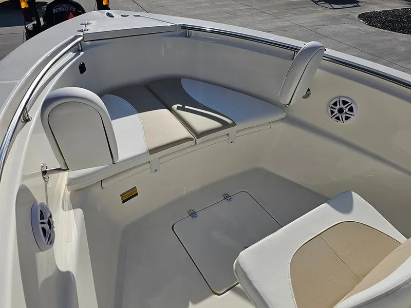 Slide: The Image of 2025 Bulls Bay 230 Center Console boat interior with cushioned seating and storage compartments. - 22