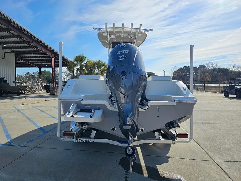 Slide: The Image of 2025 Bulls Bay 230 Center Console boat with powerful 250 V6 engine, parked outdoors. - 8