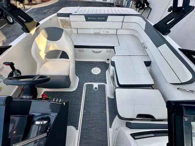 Slide: The Image of 2018 Bayliner VR5 Bowrider I/O interior with white seating and modern dashboard. - 7