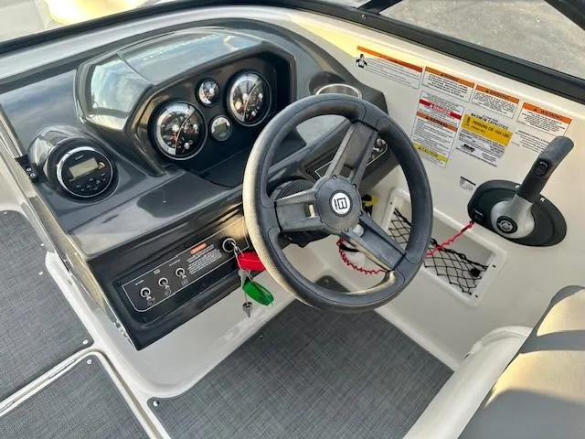 Slide: The Image of 2018 Bayliner VR5 Bowrider I/O dashboard with steering wheel and control panel. - 8
