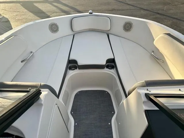 Slide: The Image of 2018 Bayliner VR5 Bowrider I/O interior with white seating and cup holders. - 9