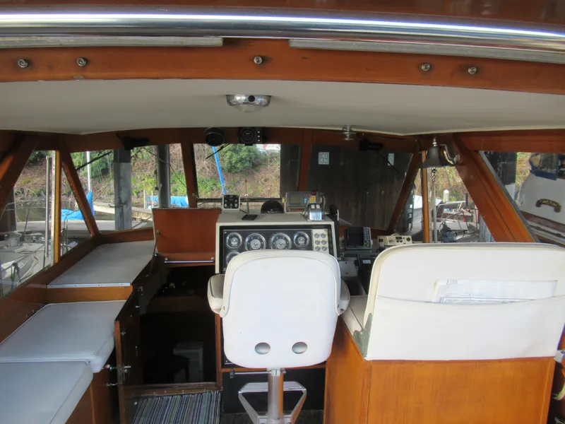 Slide: The Image of 1963 Chris-Craft Constellation boat interior with wooden accents and white seating. - 11