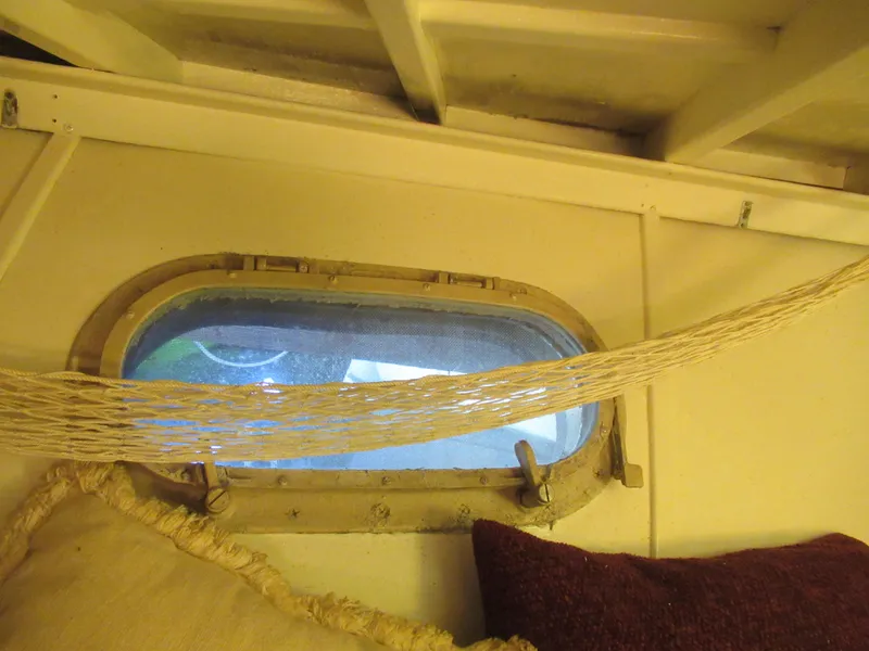 Slide: The Image of Interior of 1963 Chris-Craft Constellation with porthole, hammock, and cushions. - 17