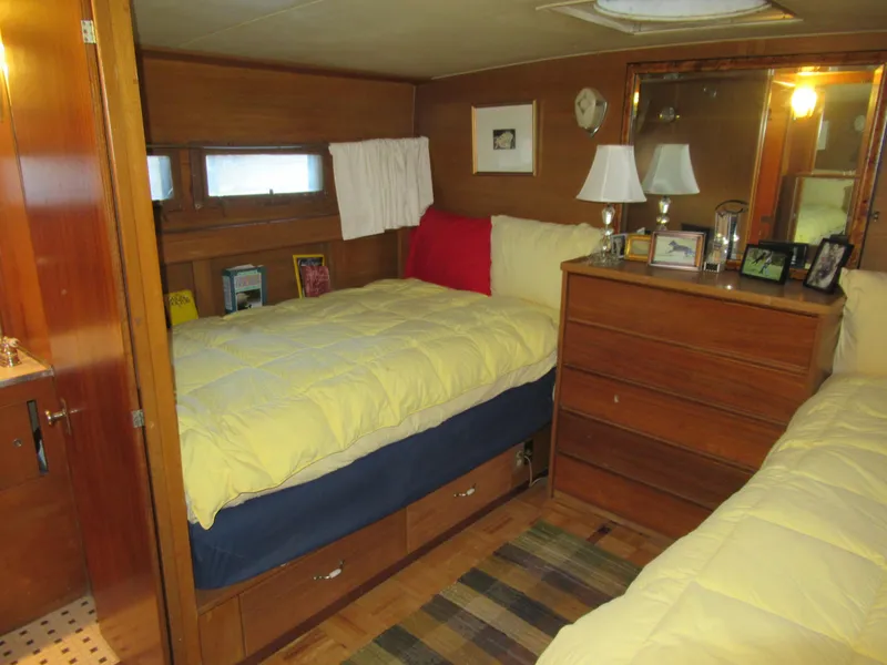 Slide: The Image of Cozy cabin interior of 1963 Chris-Craft Constellation with twin beds and wooden furnishings. - 20