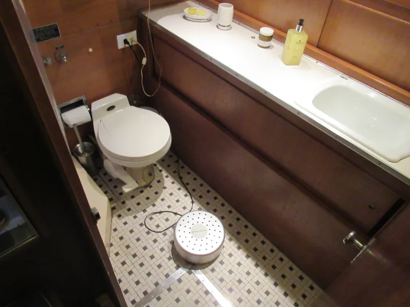 Slide: The Image of 1963 Chris-Craft Constellation bathroom with vintage fixtures and tiled floor. - 25