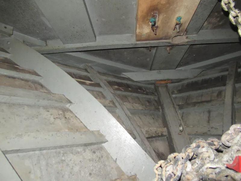 Slide: The Image of Interior view of 1963 Chris-Craft Constellation boat hull with ropes and metal structure. - 29