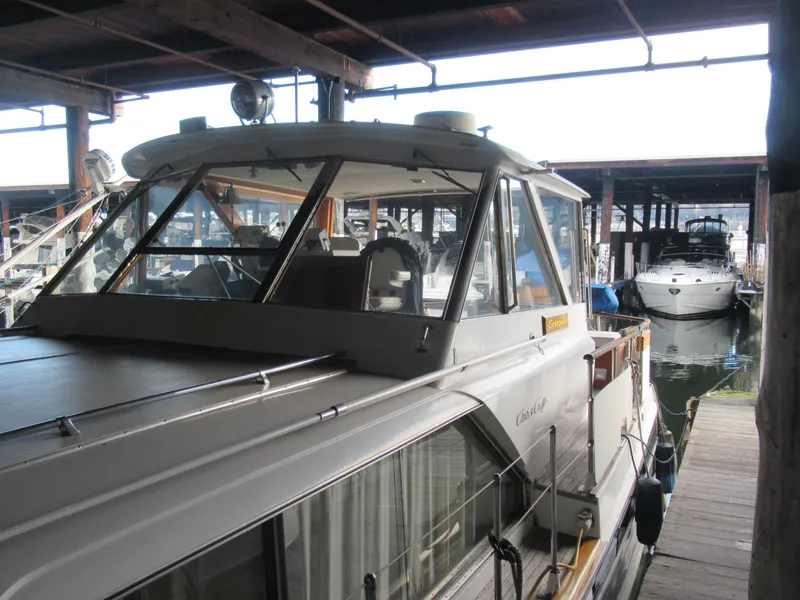 Slide: The Image of 1963 Chris-Craft Constellation boat docked in a marina under a covered structure. - 6