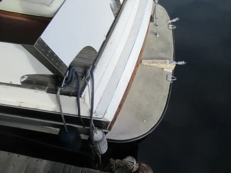 Slide: The Image of 1963 Chris-Craft Constellation boat stern with docked fenders and wooden deck details. - 7