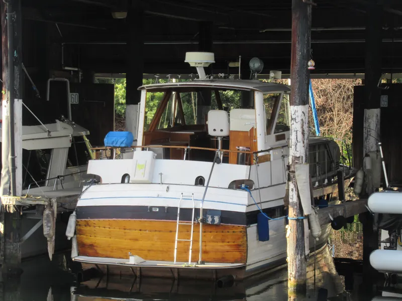 Slide: The Image of 1963 Chris-Craft Constellation boat docked in a covered marina. - 8