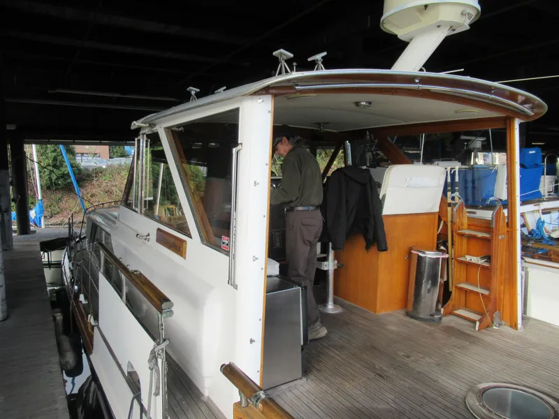 Slide: The Image of 1963 Chris-Craft Constellation boat docked, featuring wooden deck and cabin interior. - 9