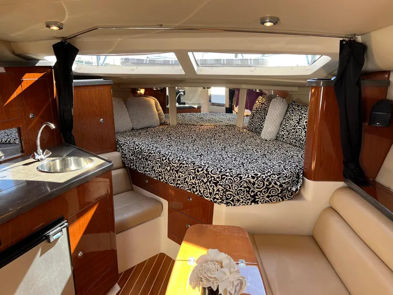 Slide: The Image of Luxurious interior of 2011 Regal 35 Express Cruiser with elegant bedding and modern amenities. - 11