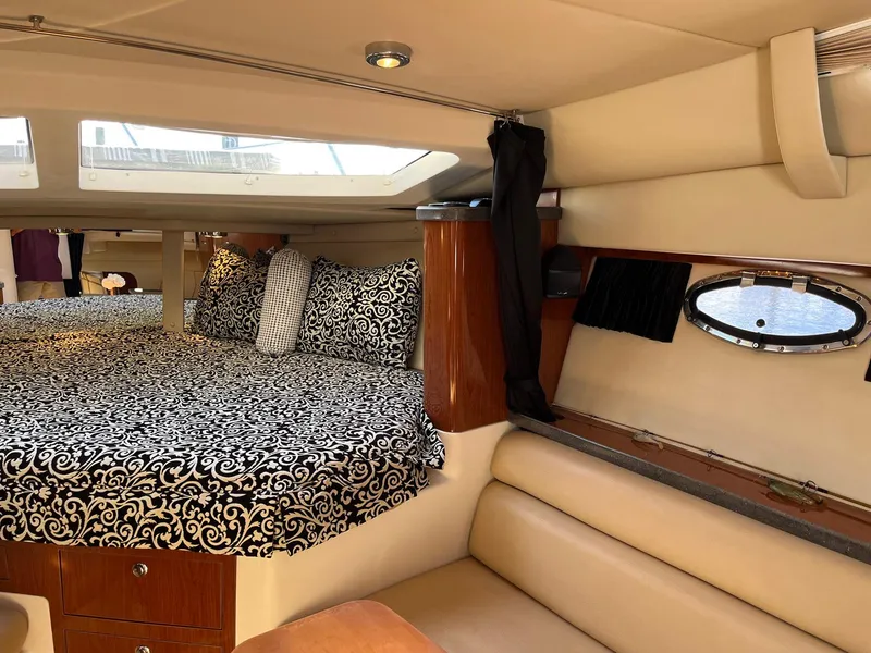 Slide: The Image of Interior of 2011 Regal 35 Express Cruiser with elegant bedding and seating. - 12