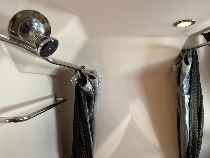 Slide: The Image of Shower area in 2011 Regal 35 Express Cruiser with chrome fixtures and curtains. - 15