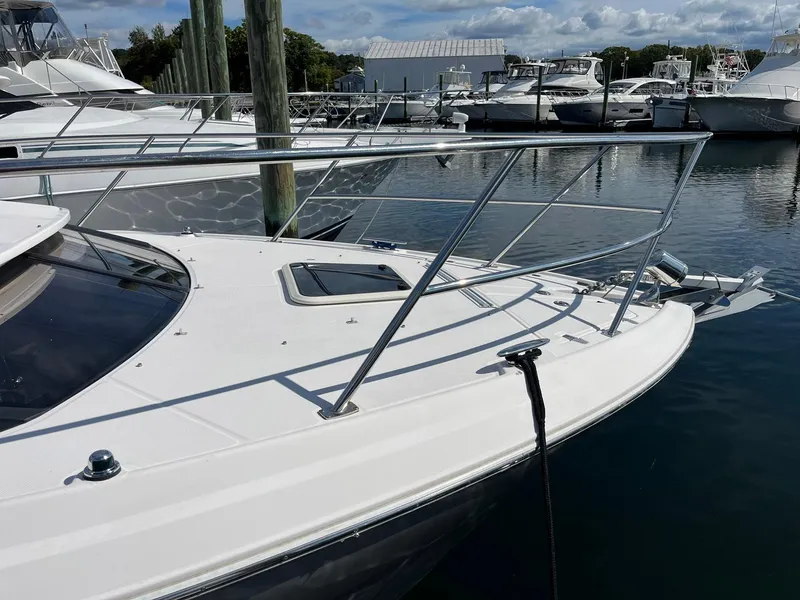 Slide: The Image of 2011 Regal 35 Express Cruiser docked at marina, showcasing sleek design and stainless steel railings. - 18