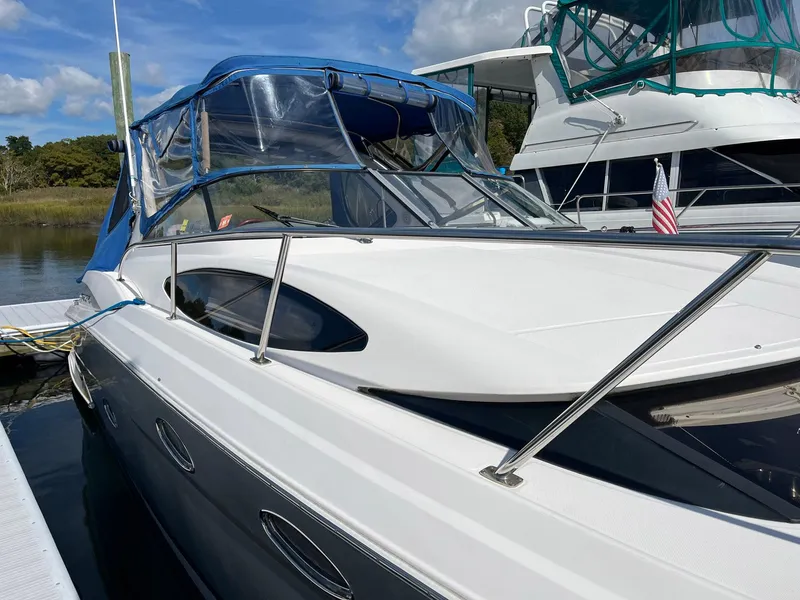 Slide: The Image of 2011 Regal 35 Express Cruiser docked, featuring sleek design and blue canopy. - 20