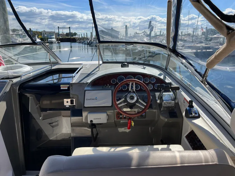 Slide: The Image of Cockpit view of 2011 Regal 35 Express Cruiser with steering wheel and navigation equipment. - 22