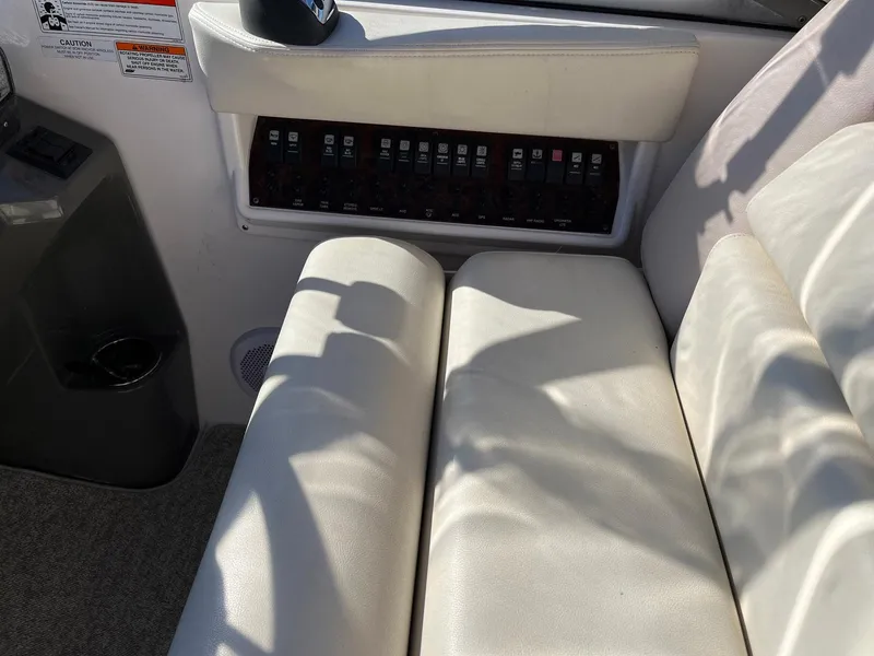 Slide: The Image of 2011 Regal 35 Express Cruiser interior with white seating and control panel. - 26