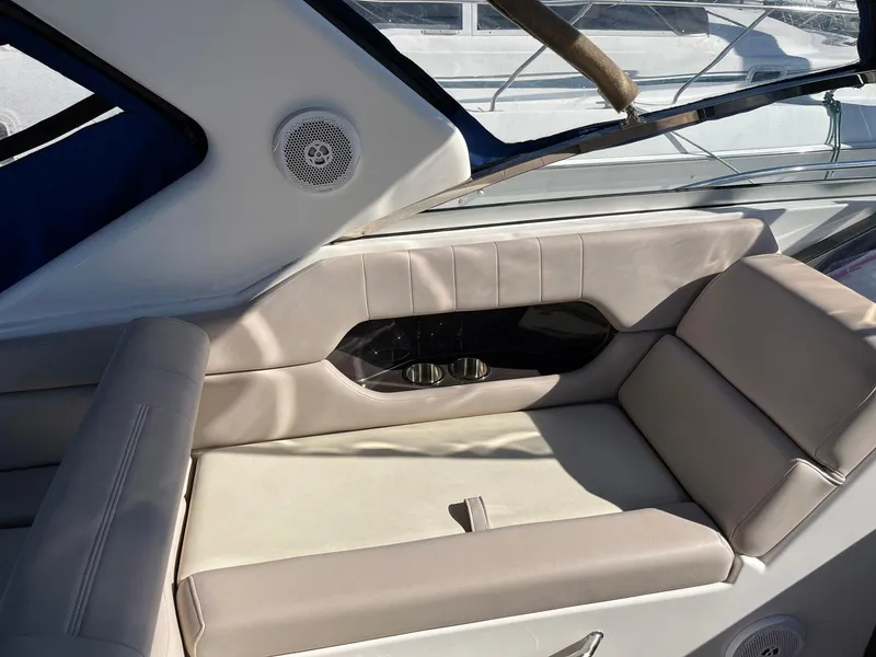 Slide: The Image of 2011 Regal 35 Express Cruiser interior seating with beige upholstery and built-in speakers. - 27